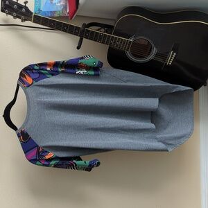 Grey top with colored sleeves and a long back